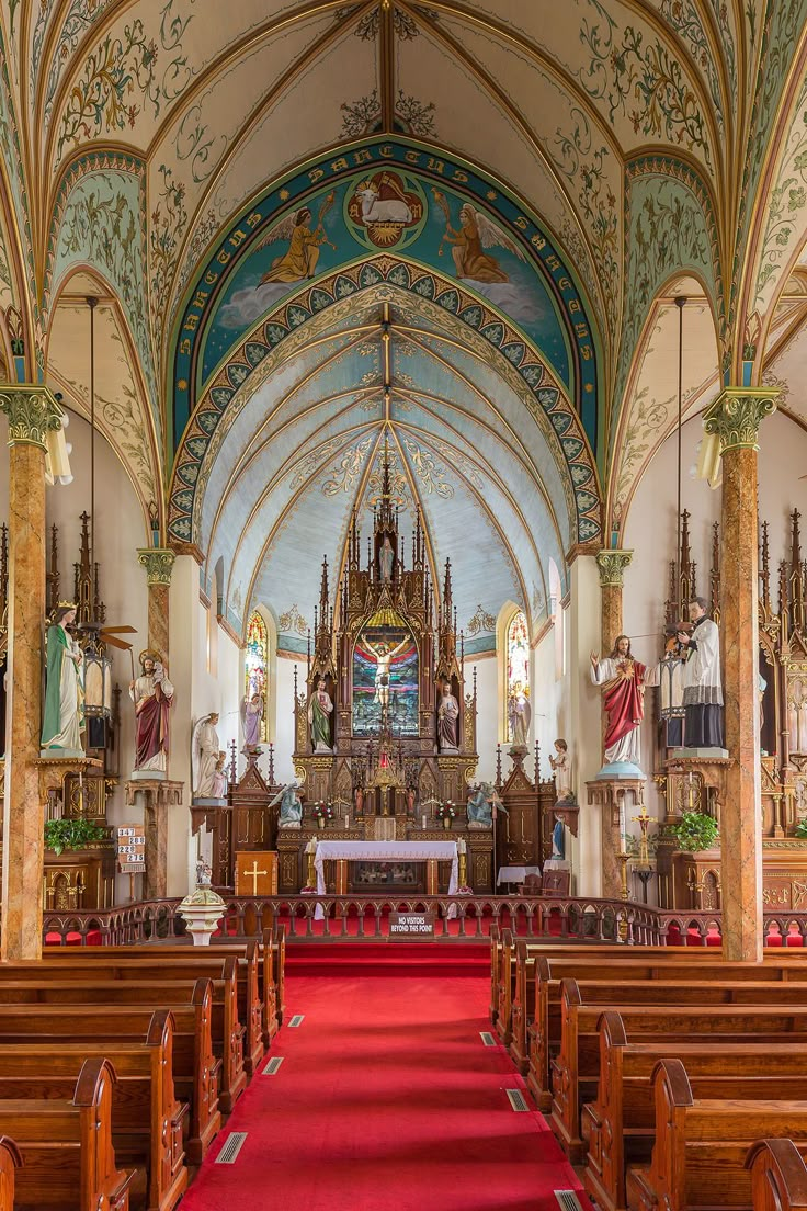 the inside of a church with pews and chandeliers