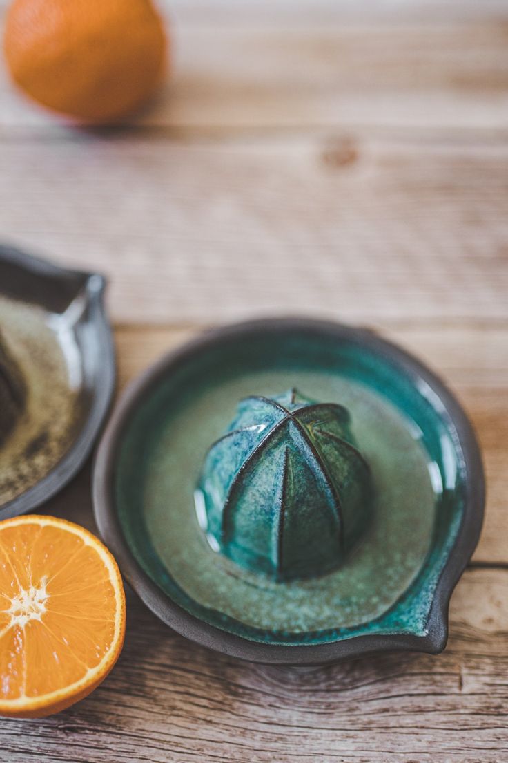 an orange sitting on top of a green plate