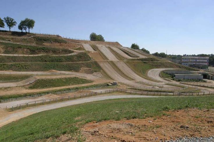 an empty dirt course with ramps on the side