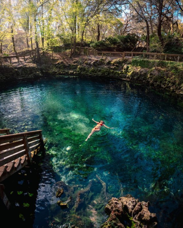 a person swimming in the blue hole