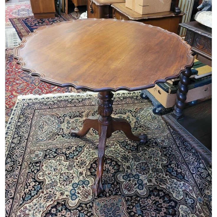 an old table is sitting on a rug