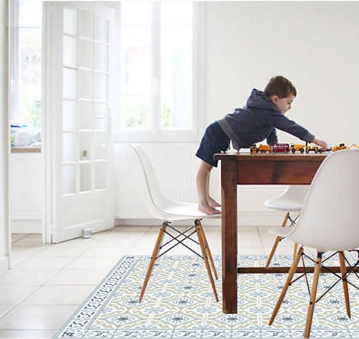 a young boy sitting at a table playing chess