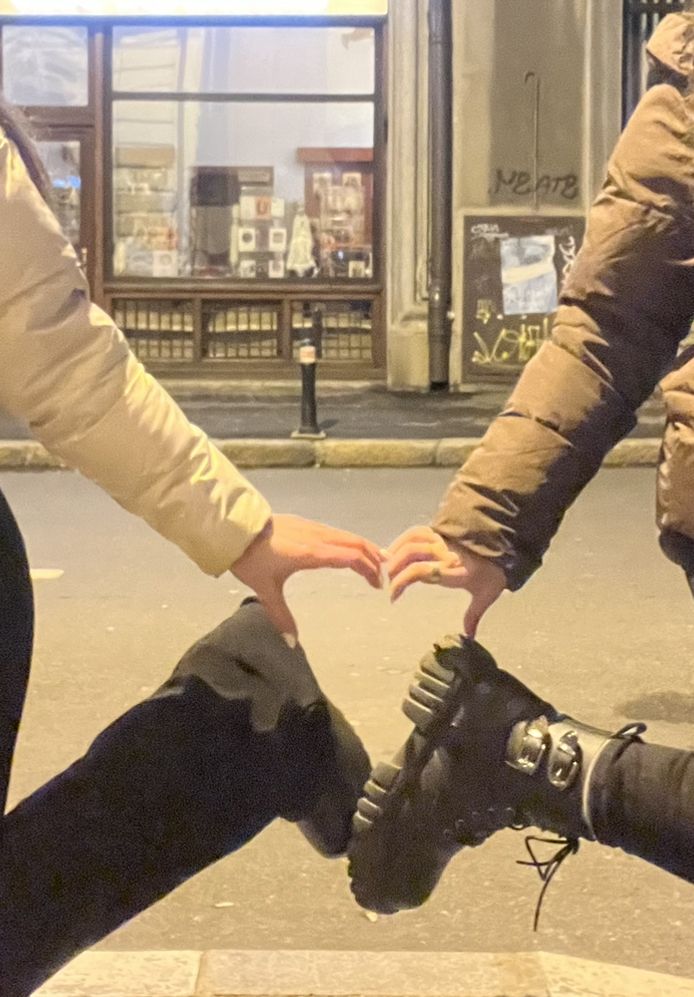 two people holding their hands together on the street