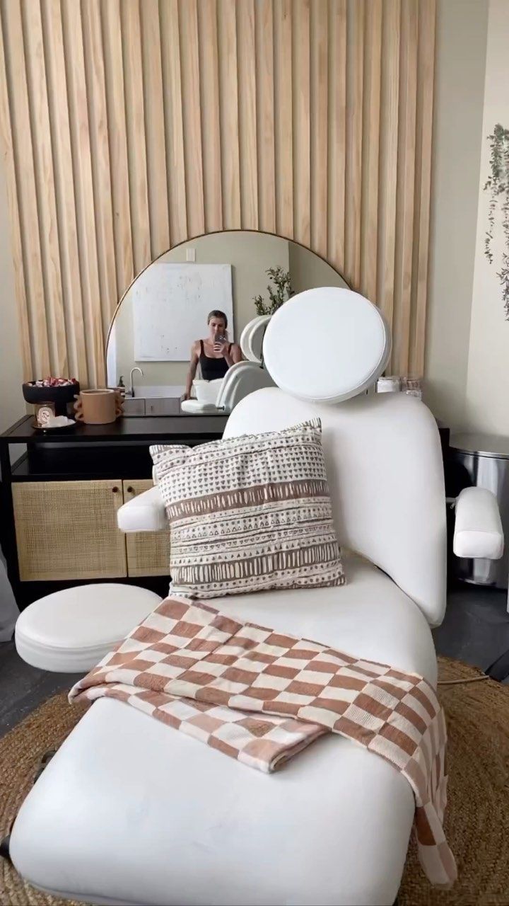 a white couch sitting in front of a mirror