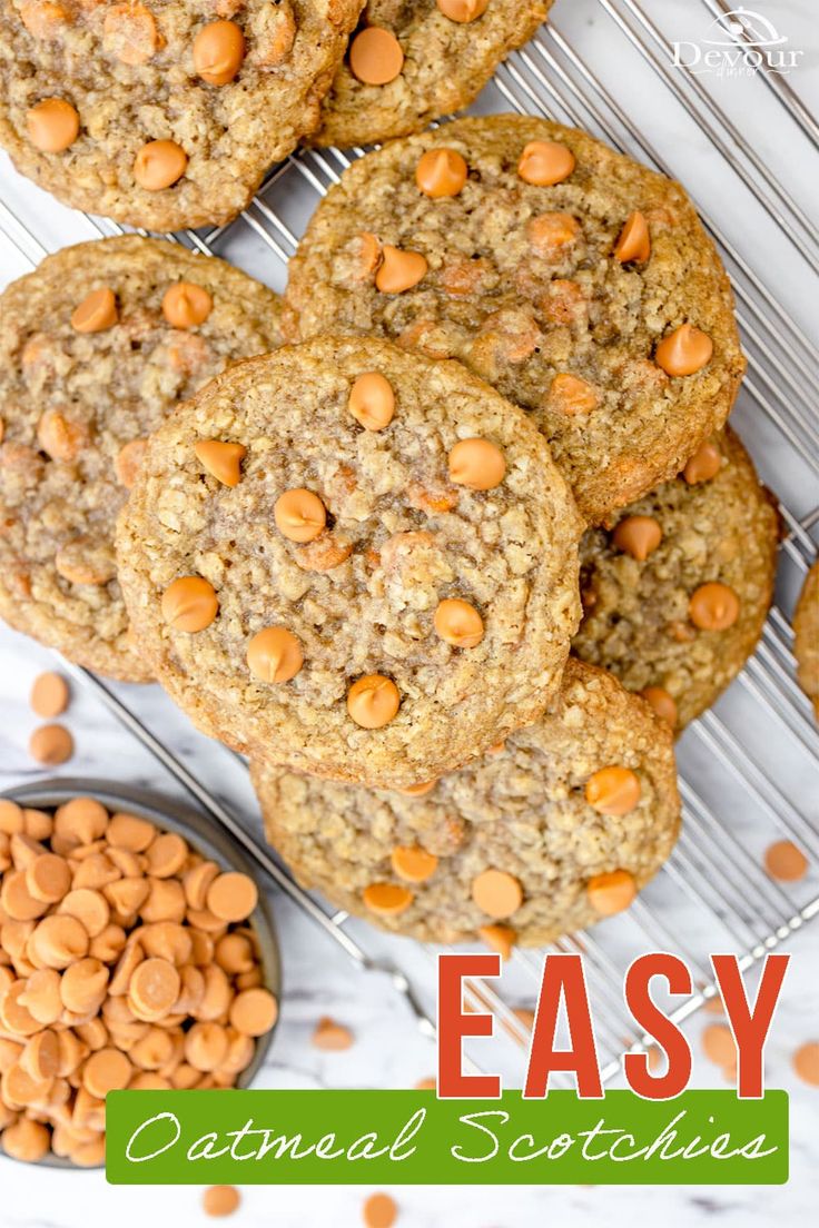 cookies with peanut butter and chocolate chips on a cooling rack next to a bowl of peanuts