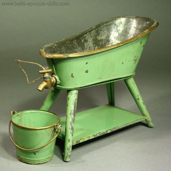 an old fashioned green tub and bucket on a gray background with gold trimmings