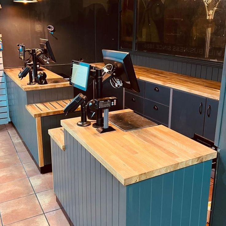 a row of desks with cameras on them in a room filled with cabinets and drawers