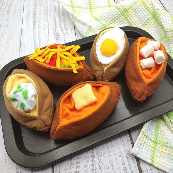 some kind of food that is on a tray with eggs and cheese in the middle