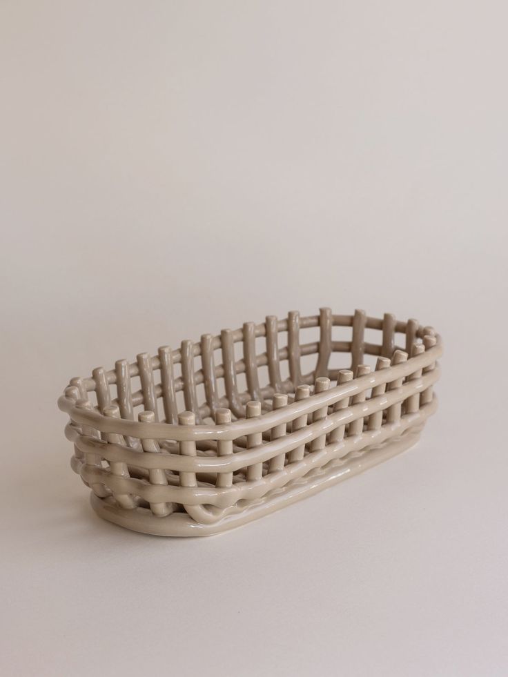 a white basket sitting on top of a table