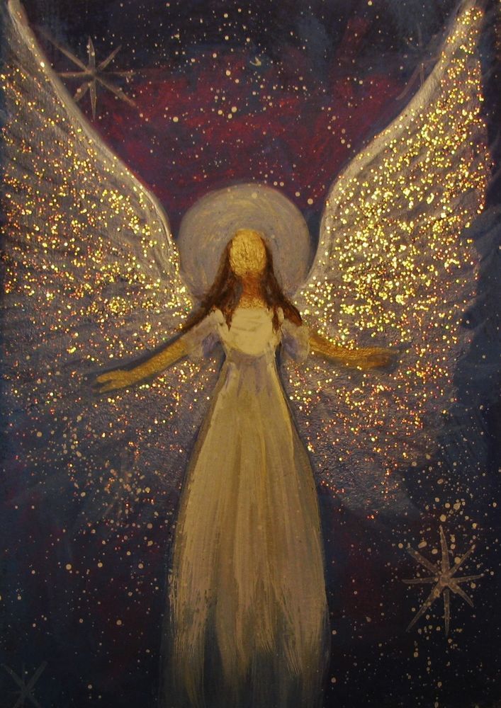 an angel with white wings and gold glitters on it's body, in front of