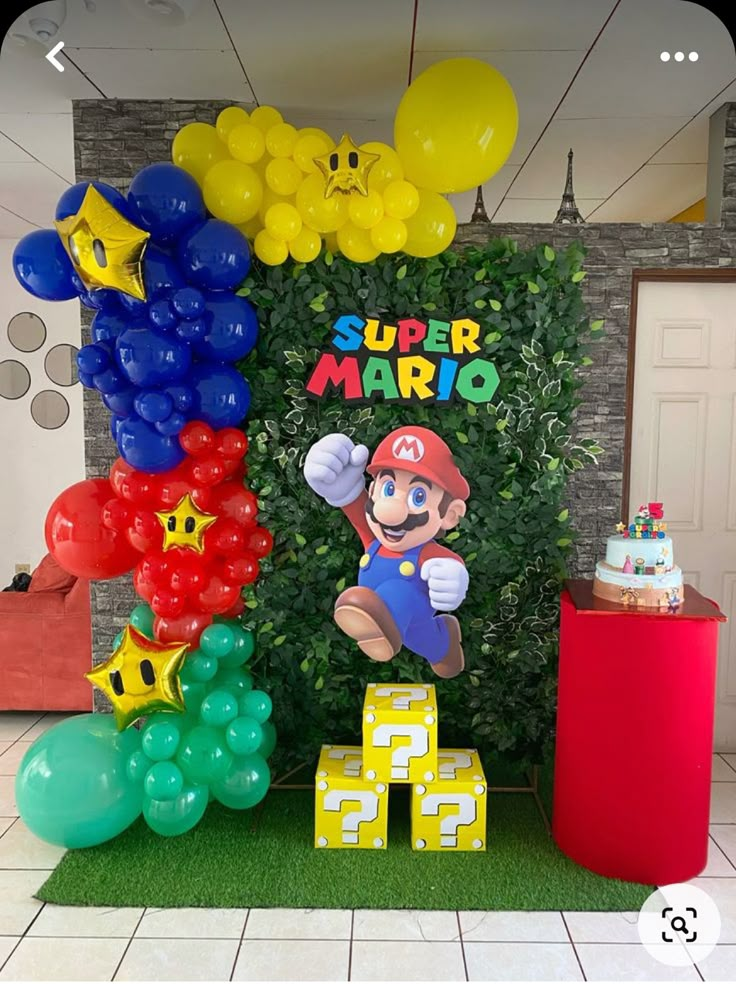 a super mario birthday party with balloons and decorations