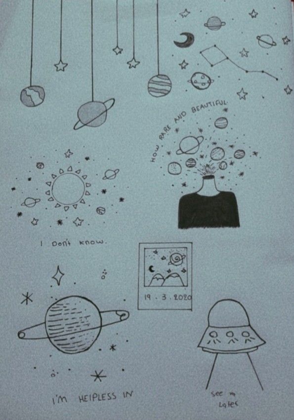 an open notebook with drawings on it and space related items in the pages, including planets