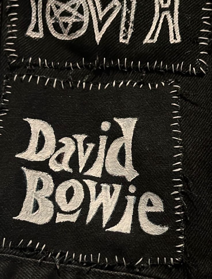 two black and white patches with the words david bowlie on them