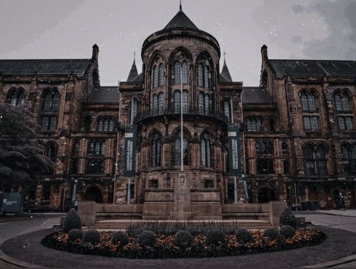 an old building with a fountain in front of it