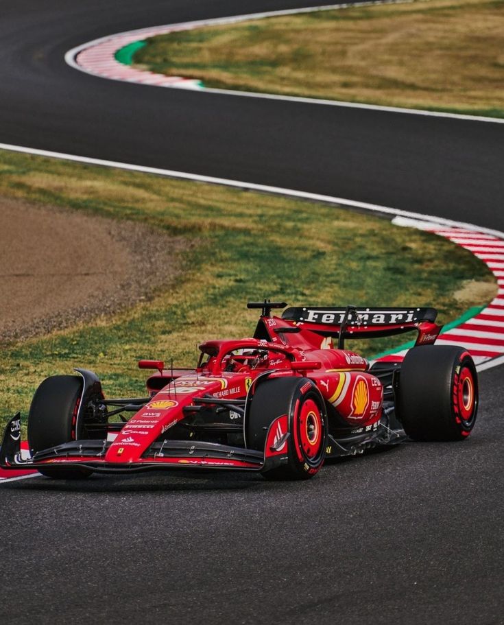 a red race car driving on a track