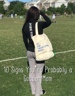 a woman carrying a bag on top of a field with the words 10 signs you're probably a soccer mom