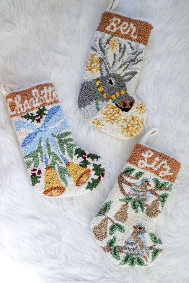 three handmade christmas stockings with animals on them