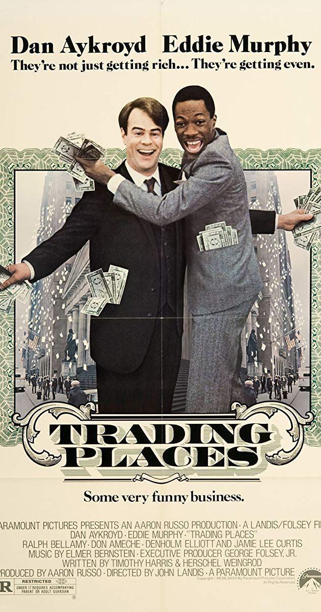 a movie poster with two men in suits hugging each other and holding money on their arms