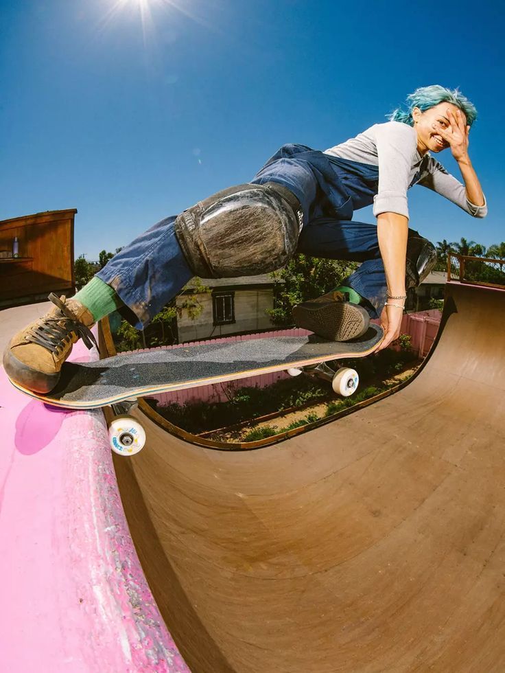 a man riding a skateboard up the side of a ramp in a skate park