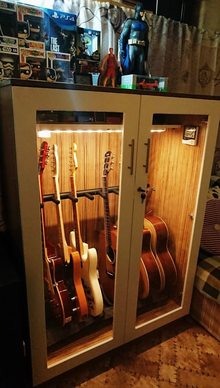 an open cabinet with guitars in it