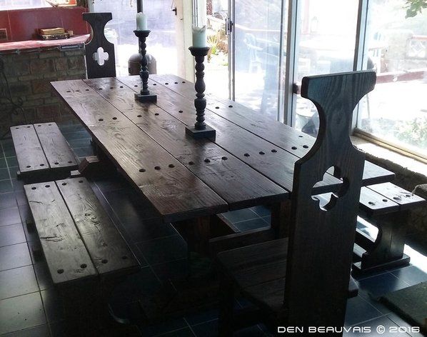 a wooden table and benches in a room