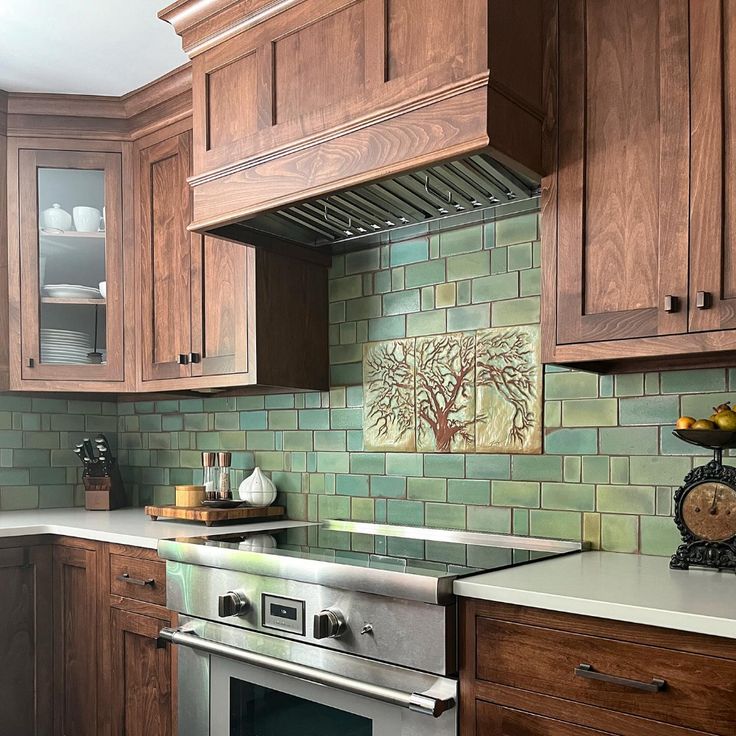 a kitchen with wooden cabinets and green tile backsplash, stainless steel range hood