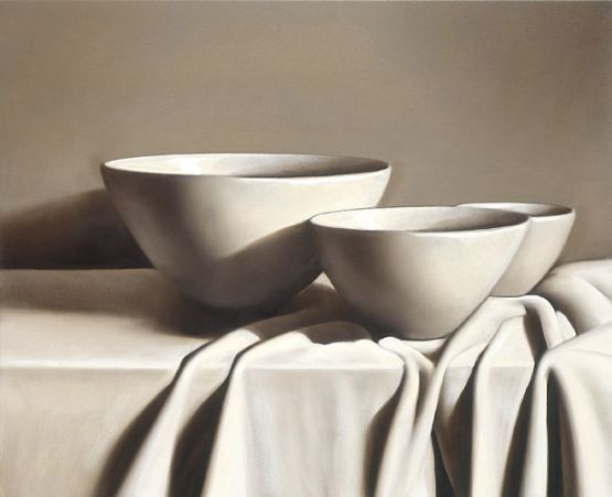 three white bowls sitting on top of a table covered in a white cloth next to each other