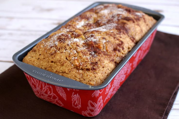 a loaf of bread sitting on top of a red pan