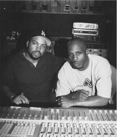 two men sitting next to each other in front of sound mixing equipment