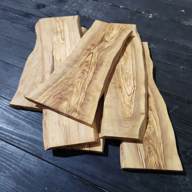 four pieces of wood sitting on top of a wooden table