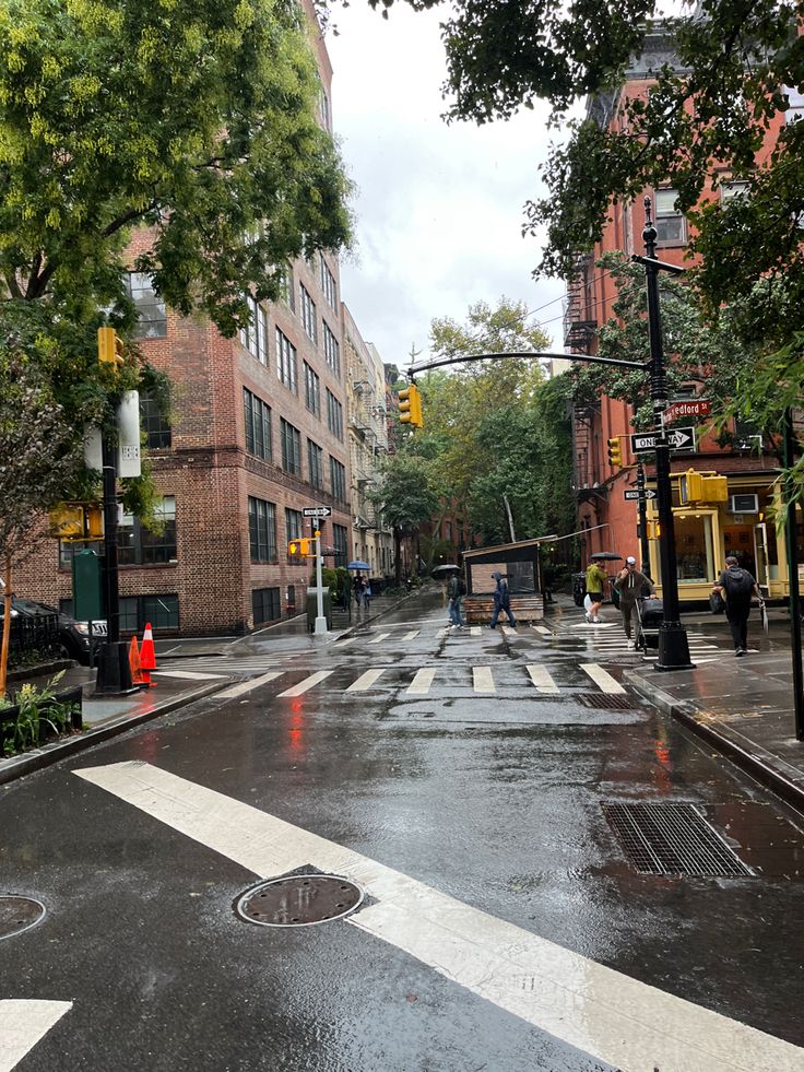 an empty city street is shown in the rain