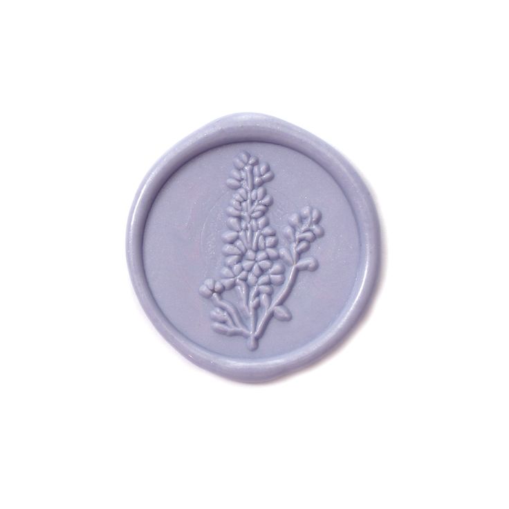 a wax stamp with a flower design on the front and back of it's seal