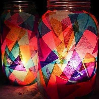 two jars with colorful lights in them sitting next to each other