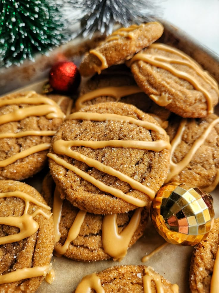 some cookies with icing on top of them next to a christmas tree ornament