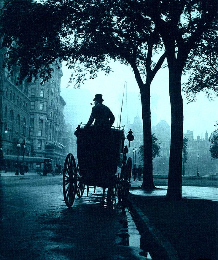 an old photo of a man riding in a horse - drawn carriage down the street