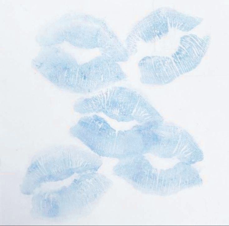 four blue lips are arranged on a white surface