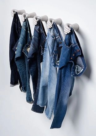 several pairs of jeans hanging on a clothes rack