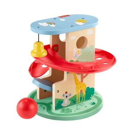 a wooden toy house with toys on the floor and around it's base, including a ball