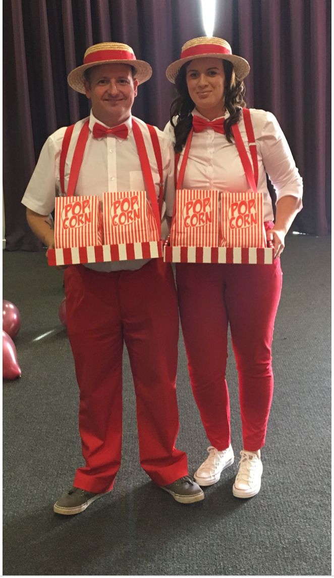 two people dressed in red and white standing next to each other