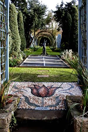 an open door leading into a lush green garden