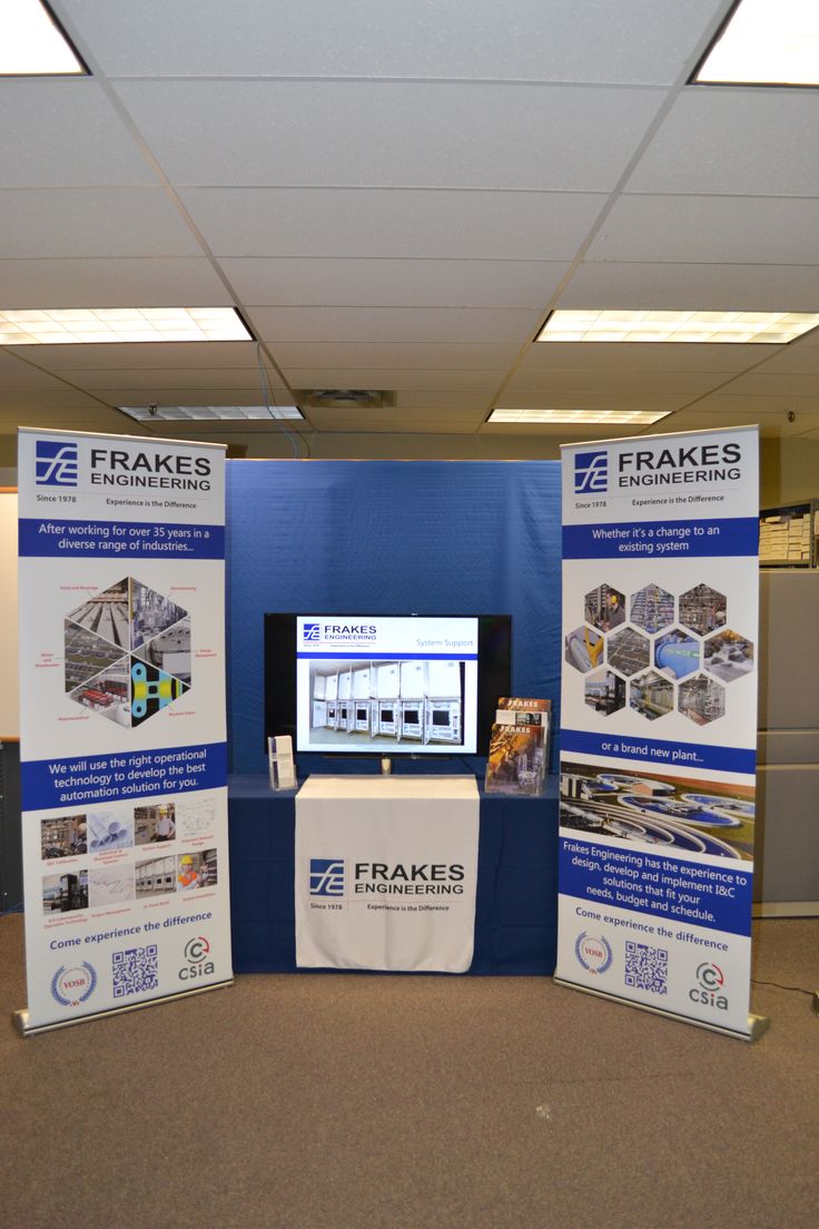 a trade show booth with blue walls and white signs on the wall that say frakes