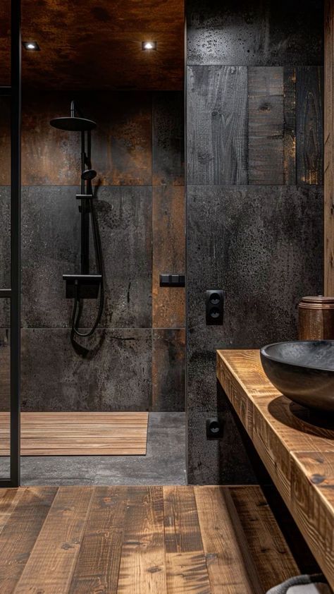 a bathroom with wooden flooring and black walls, along with a glass shower stall