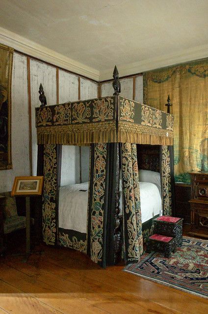 a canopy bed sitting in the middle of a bedroom