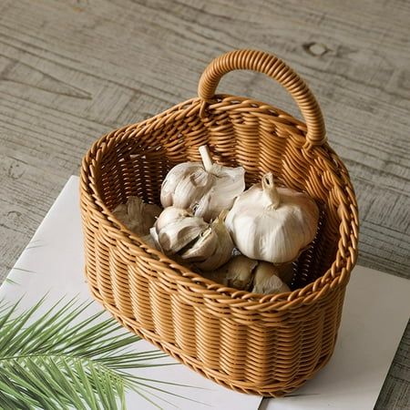 a basket filled with garlic sitting on top of a table