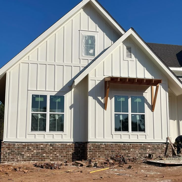 a house being built in the middle of a construction area with brickwork on the ground