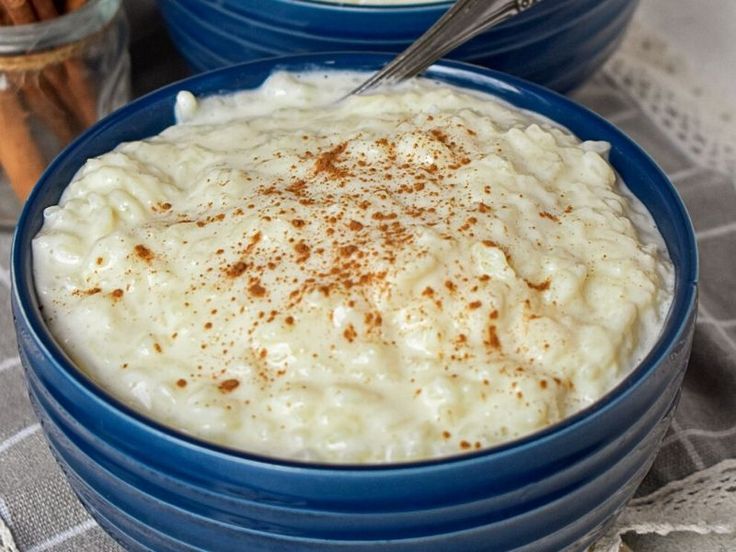 two blue bowls filled with mashed potatoes and cinnamon sticks