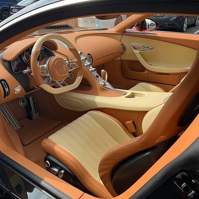 the interior of a sports car with brown leather