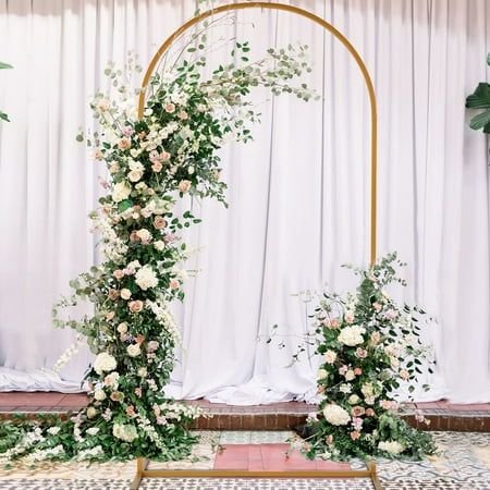 the wedding arch is decorated with flowers and greenery