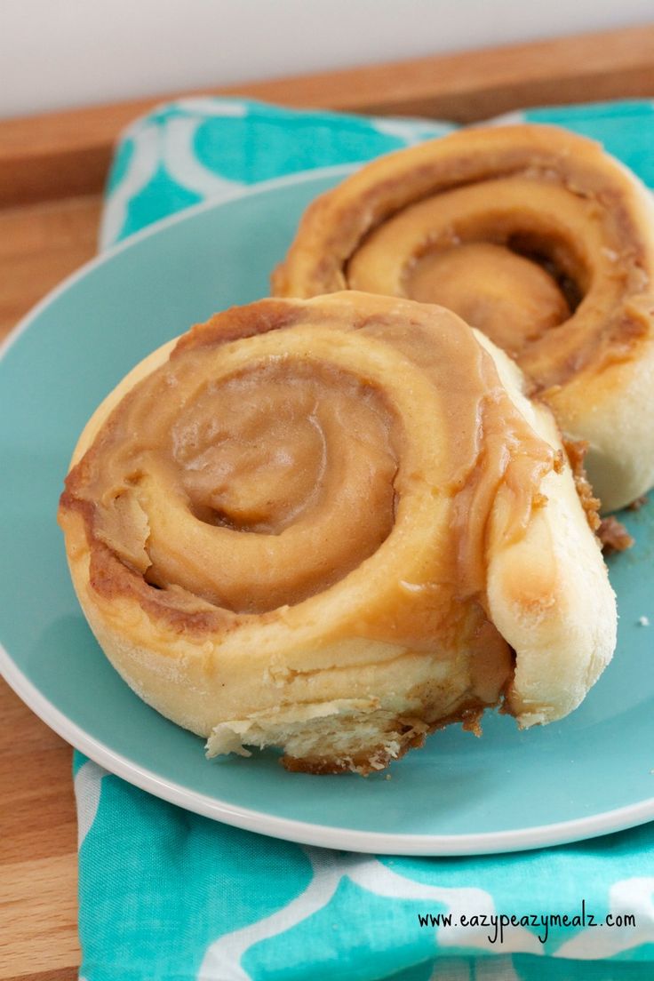 two cinnamon rolls on a blue plate