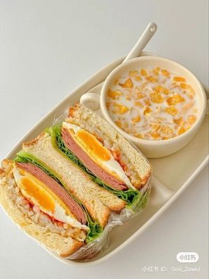 a sandwich and bowl of soup on a white plate